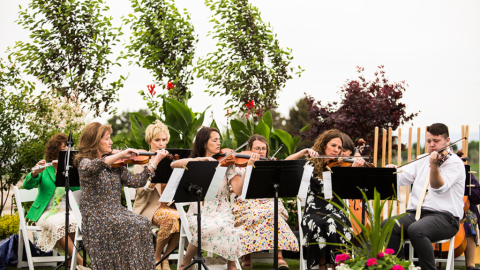 Local members perform the hymn "I Know that My Redeemer Lives" with violins, flutes, and cellos at the Burley Idaho Temple groundbreaking ceremony.