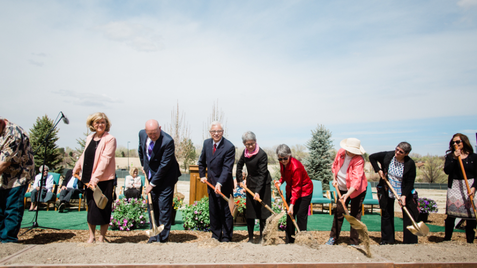 A small group of invited guests turn shovels of dirt for the groundbreaking for the Grand Junction Colorado Temple.