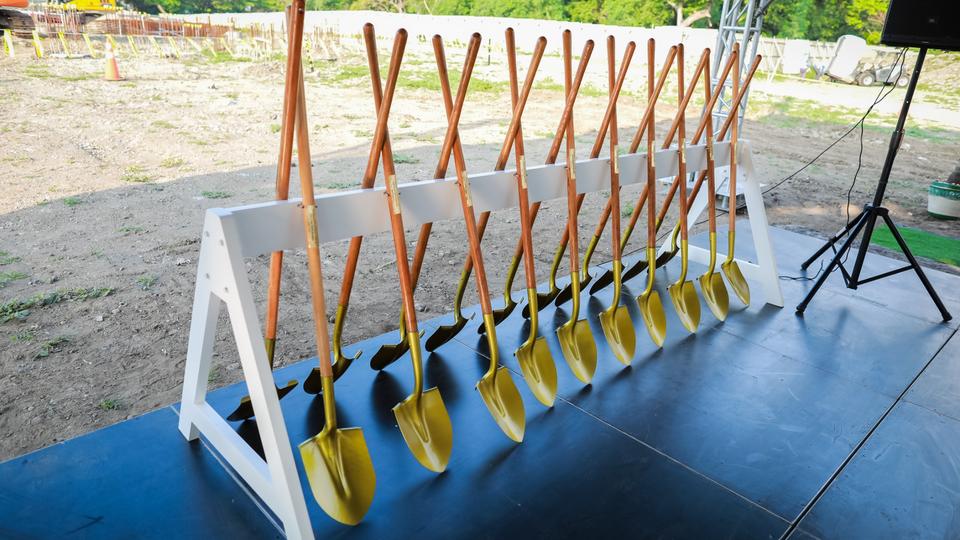 A row of ceremonial golden shovels standing up.
