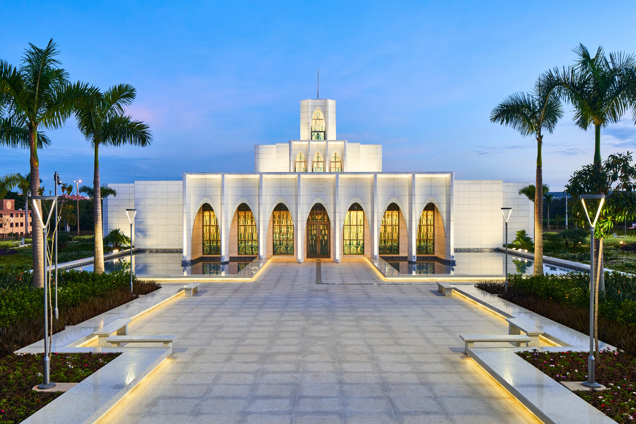 The exterior of the Brasília Brazil Temple, a white building surrounded by archways.