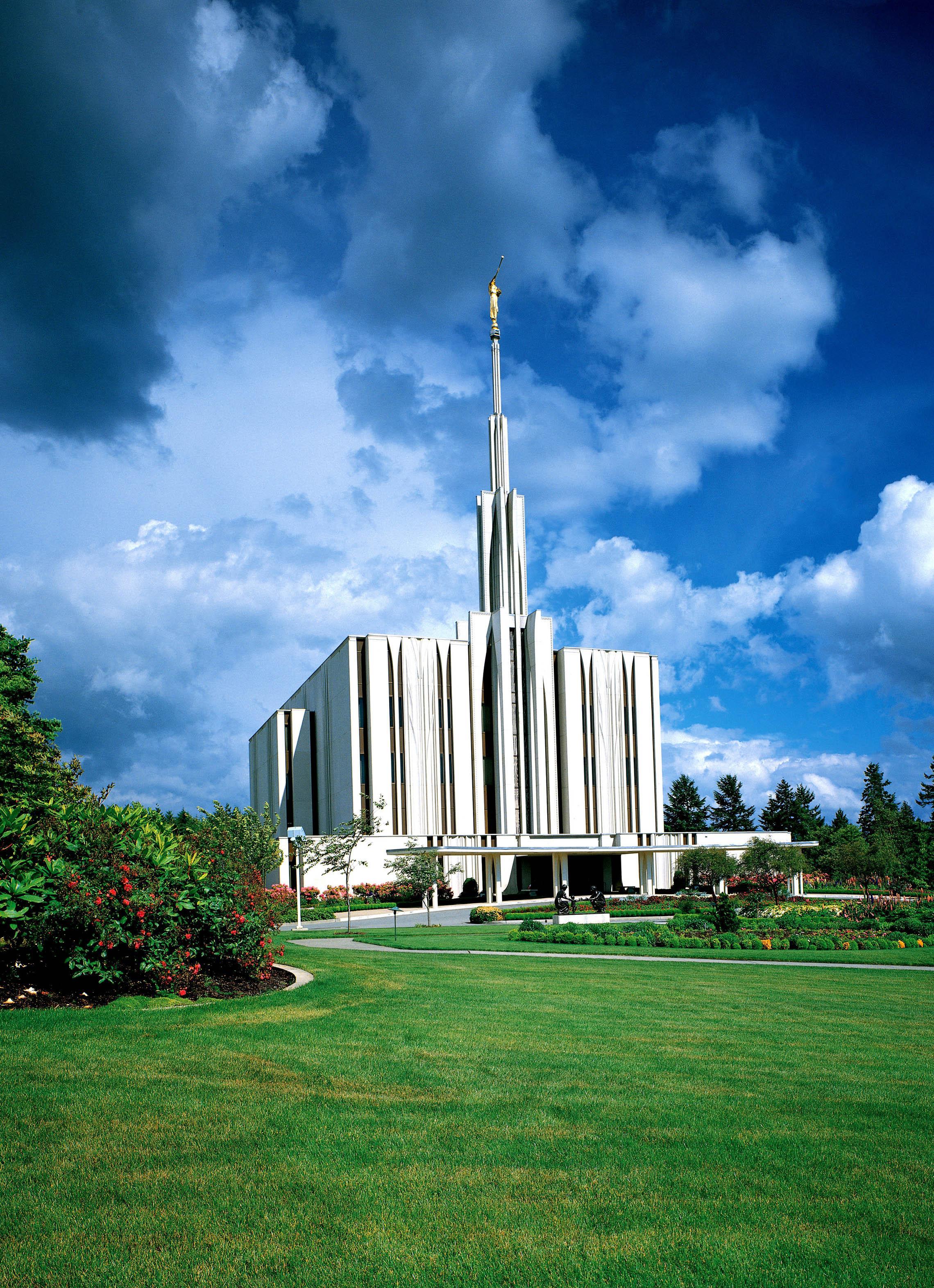 The Seattle Washington Temple, a white building with a steeple topped by a golden statue of an angel blowing a trumpet.