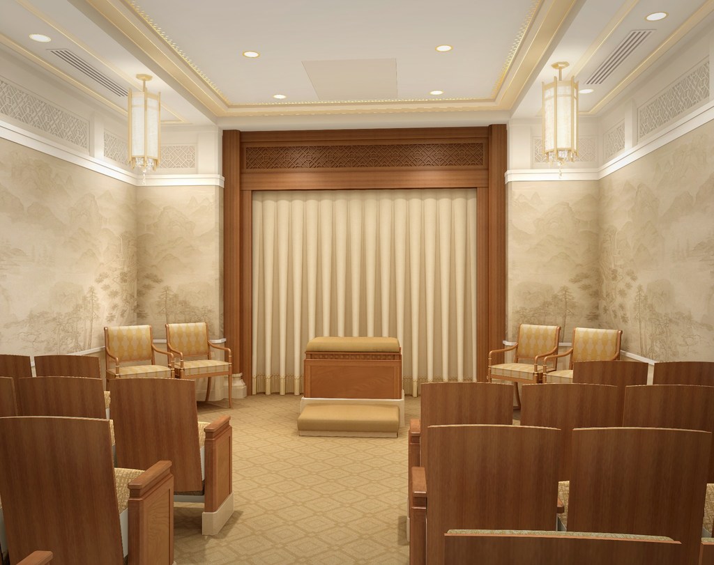 A temple instruction room, with a veil on the wall, an alter near the veil, and rows of chairs.