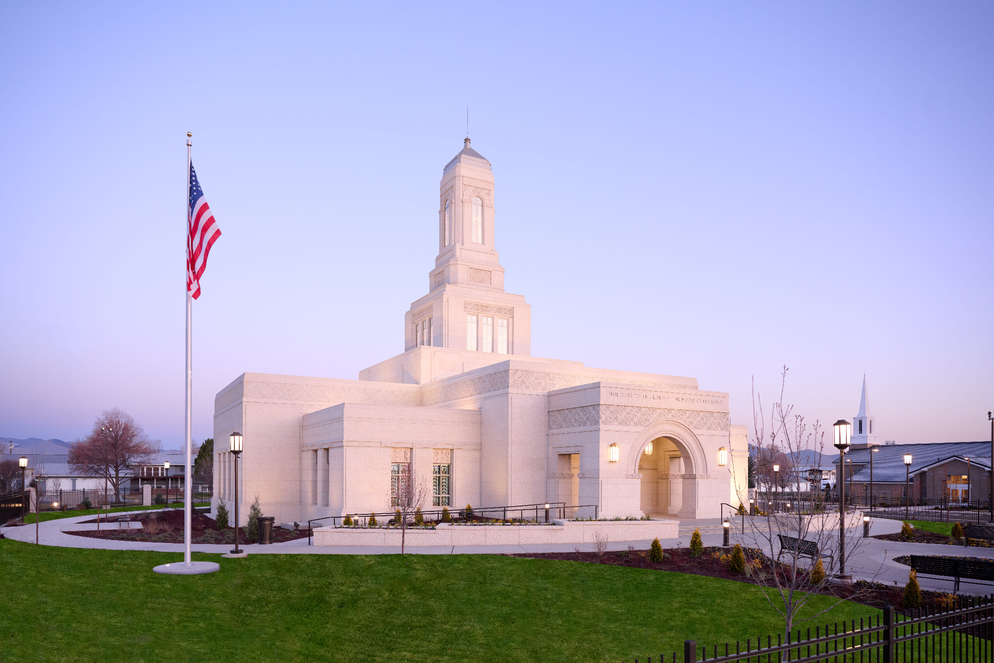 An exterior photograph of the Helena Montana Temple, a white building with a five-tiered tower that sits on a square base.