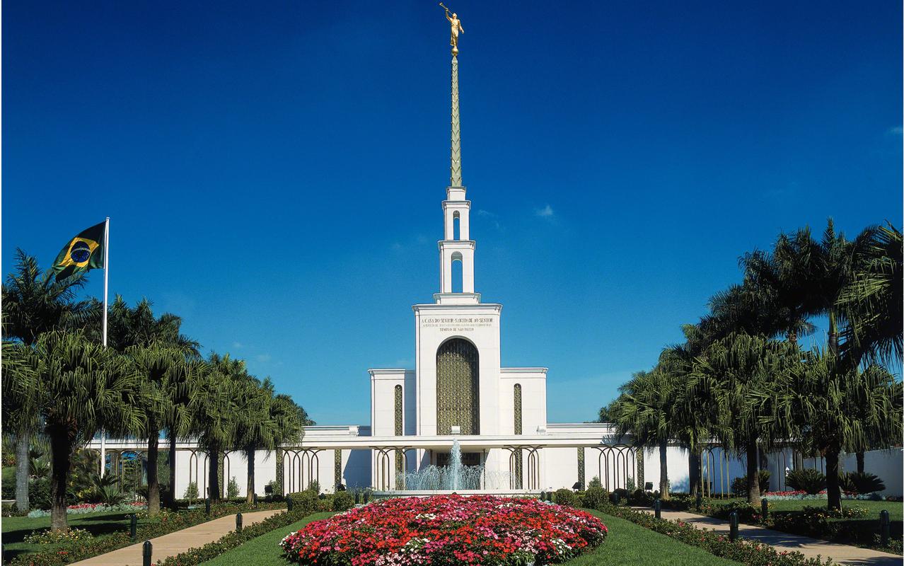 The São Paulo Brazil Temple, a white building with a steeple topped by a golden statue of an angel blowing a trumpet.