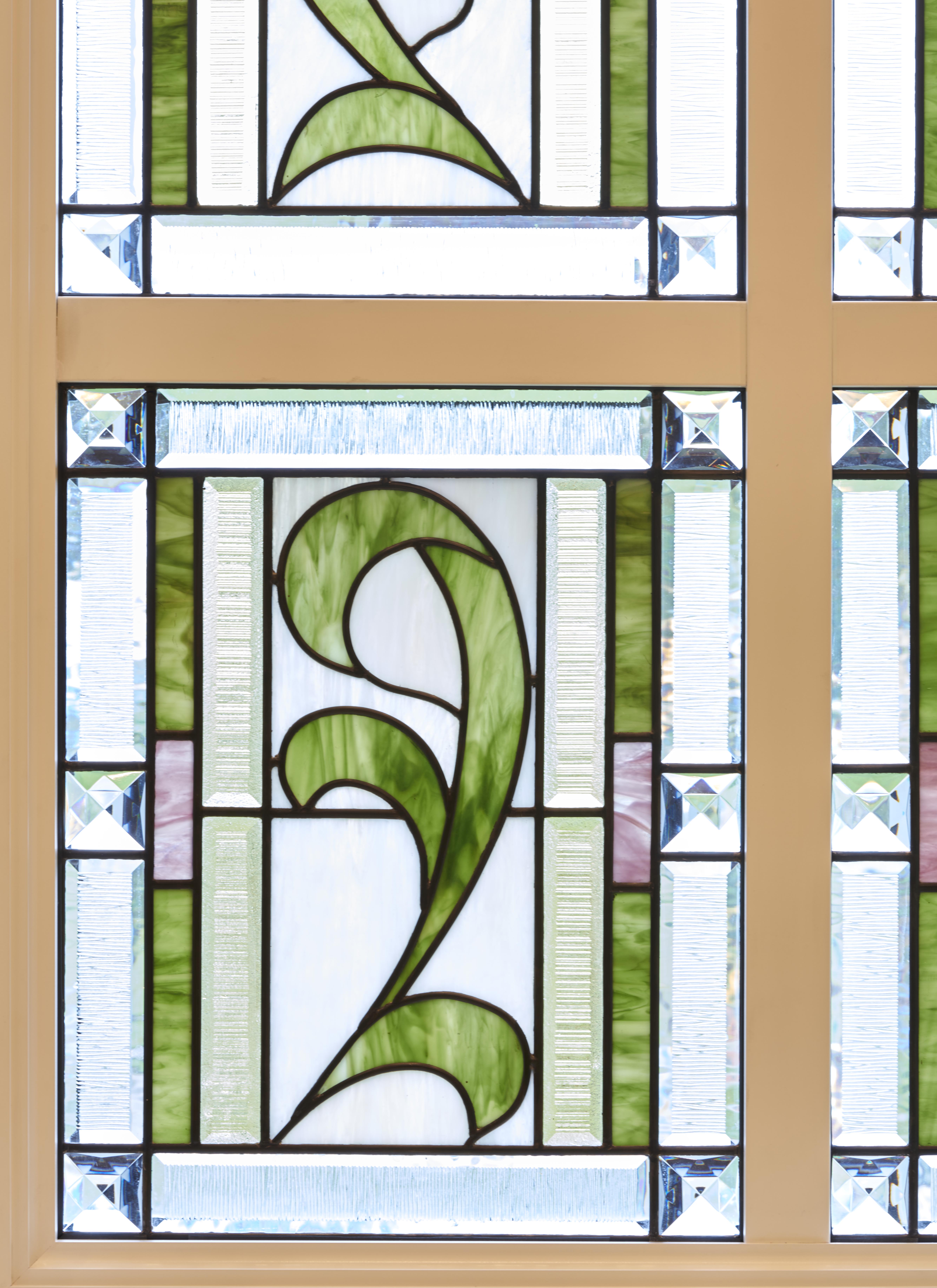 Glass art depicting a green vine.
