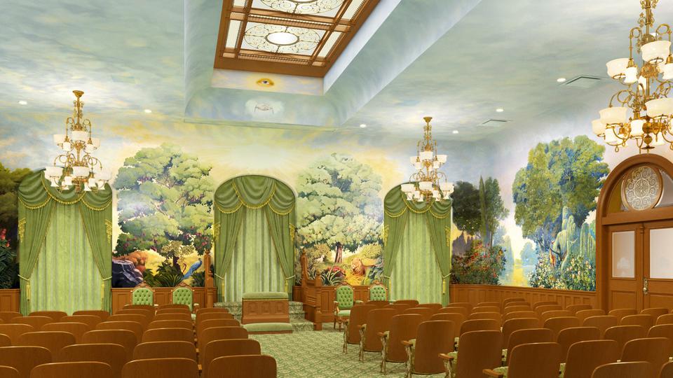 A room filled with chairs, with a mural of trees and bushes all around the walls.