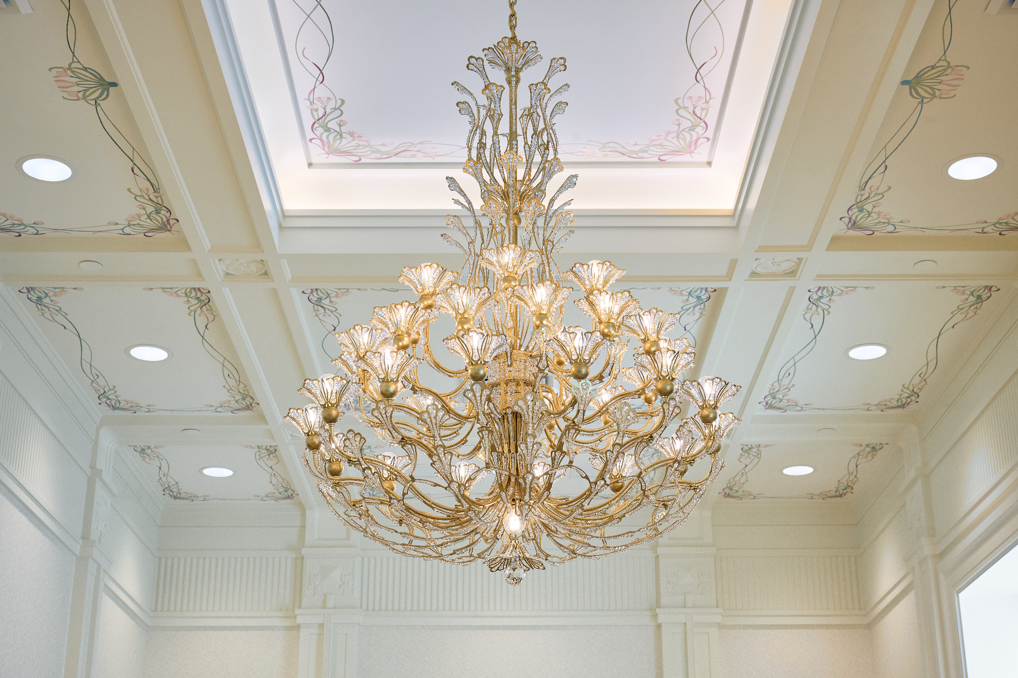 A chandelier with a flower-shaped design around each lightbulb.