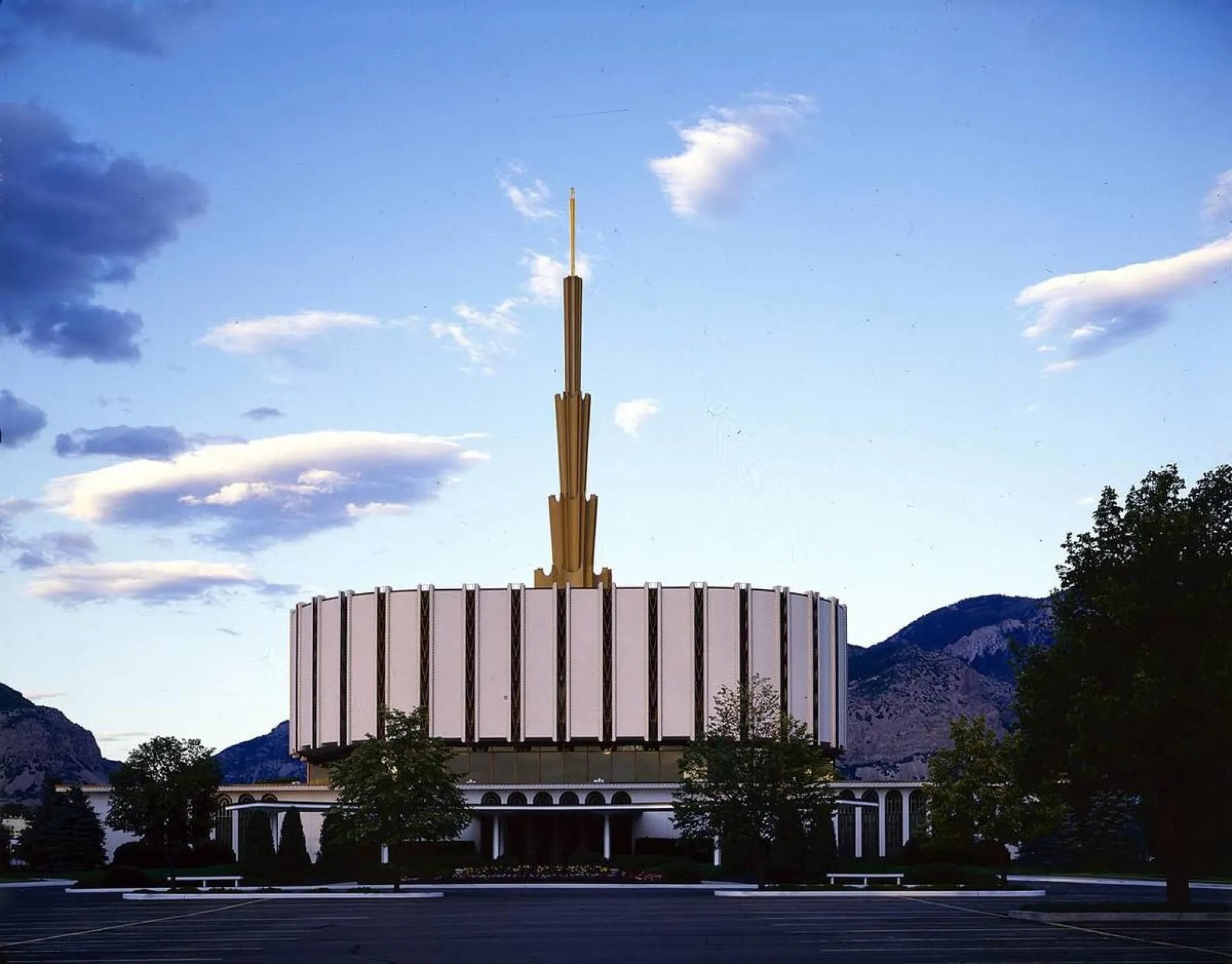 A sunset view of the original Ogden Utah Temple, dedicated in 1972, that had a flat, round base with a spire in the center.