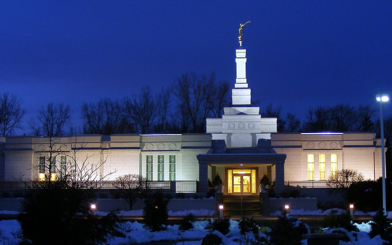 The St. Paul Minnesota Temple, a white building with a steeple topped by a golden statue of an angel blowing a horn.