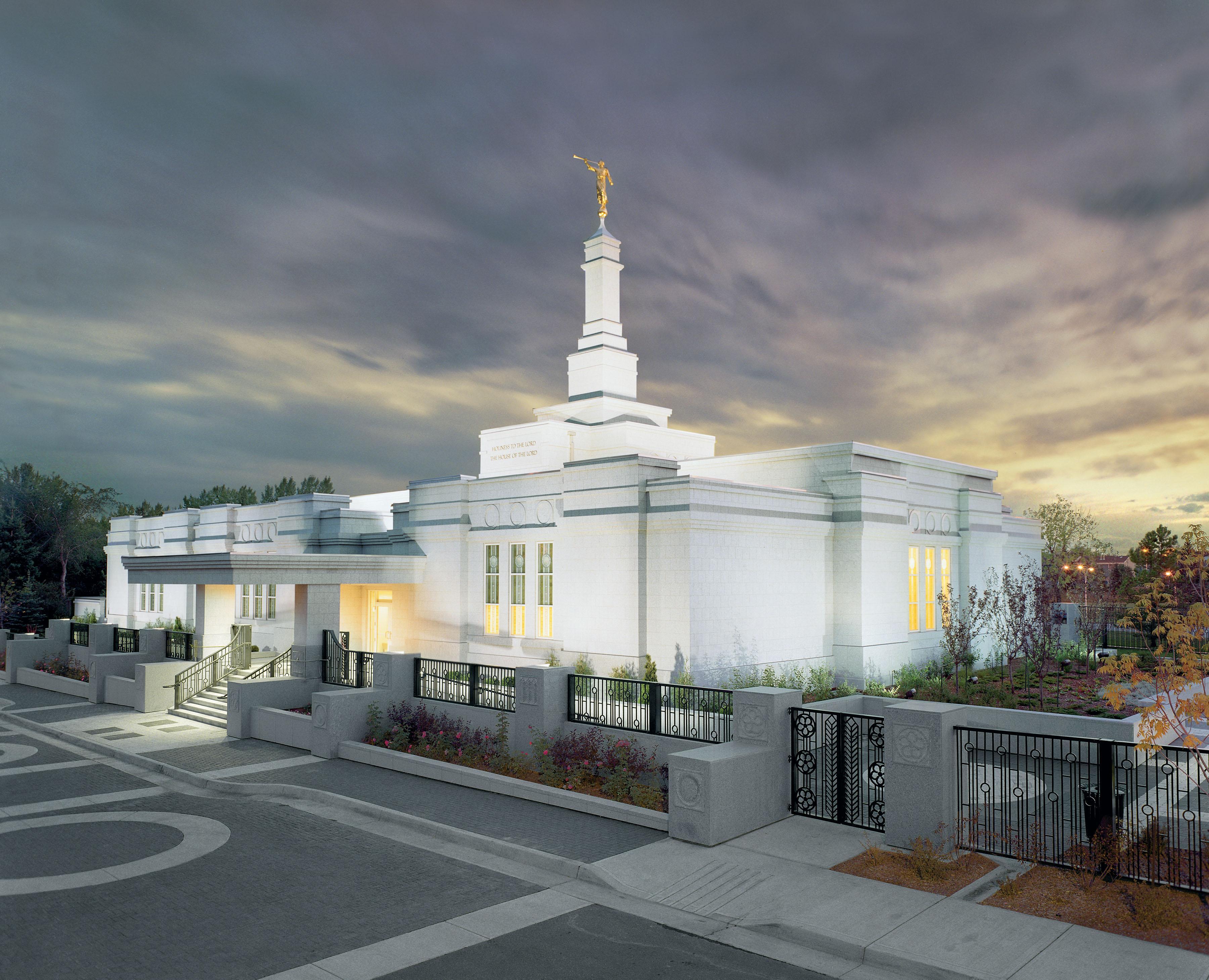 The Edmonton Alberta Temple, a white building with a steeple topped by a golden statue of an angel blowing a trumpet.