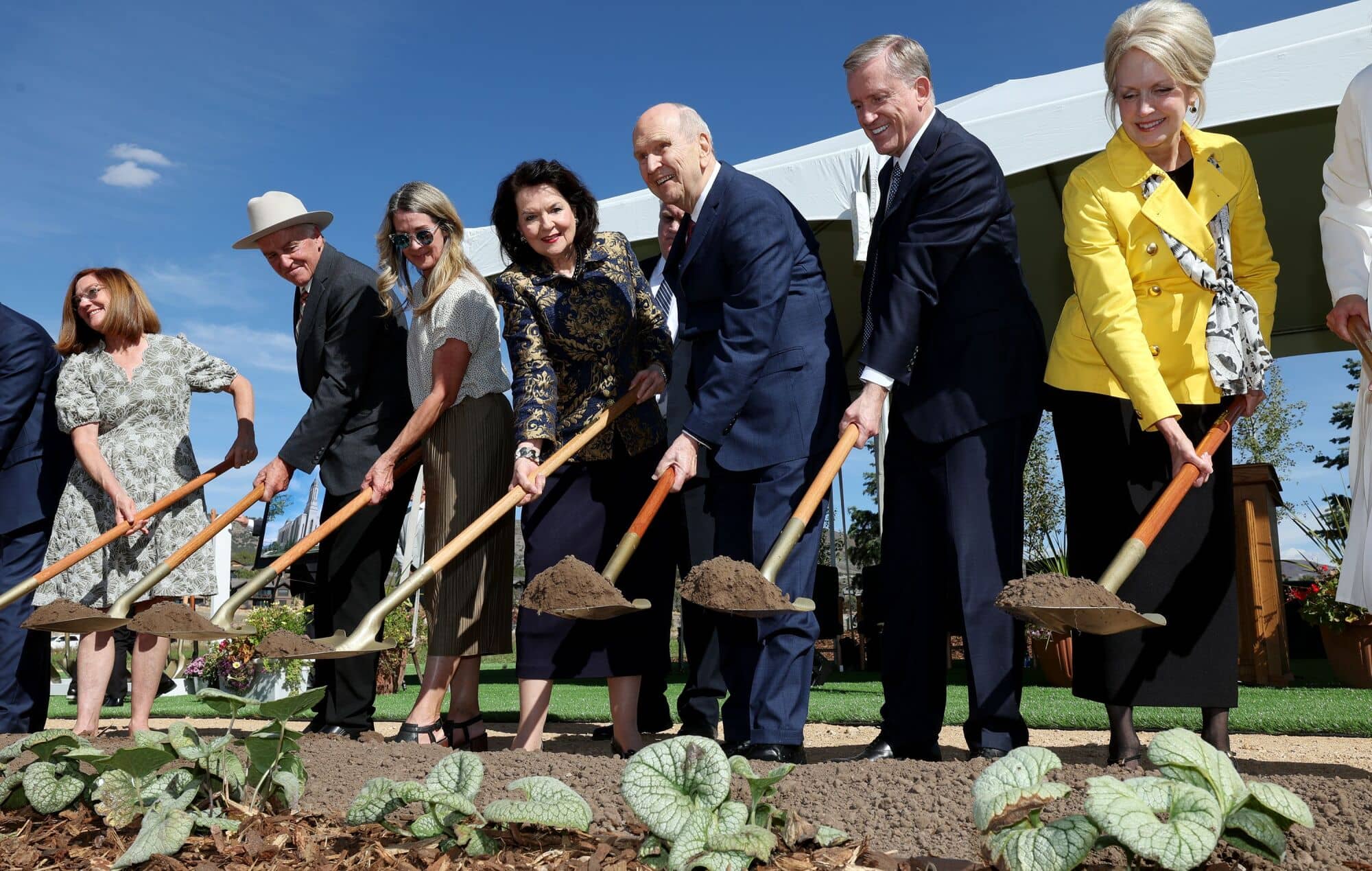 President Russell M. Nelson and others holding shovels into the ground.