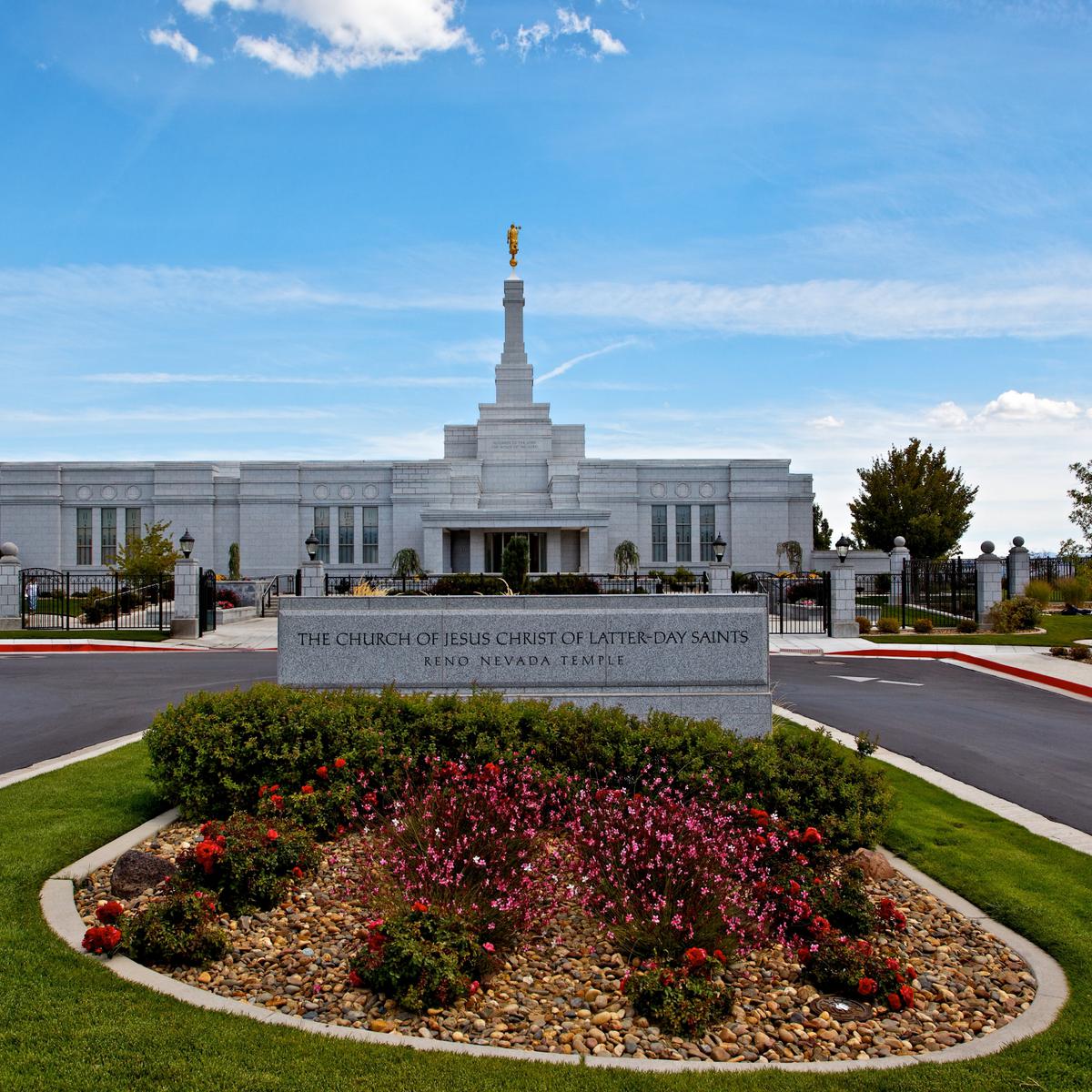 The Reno Nevada Temple, a white building with a central spire topped by a golden statue of an angel blowing a trumpet.