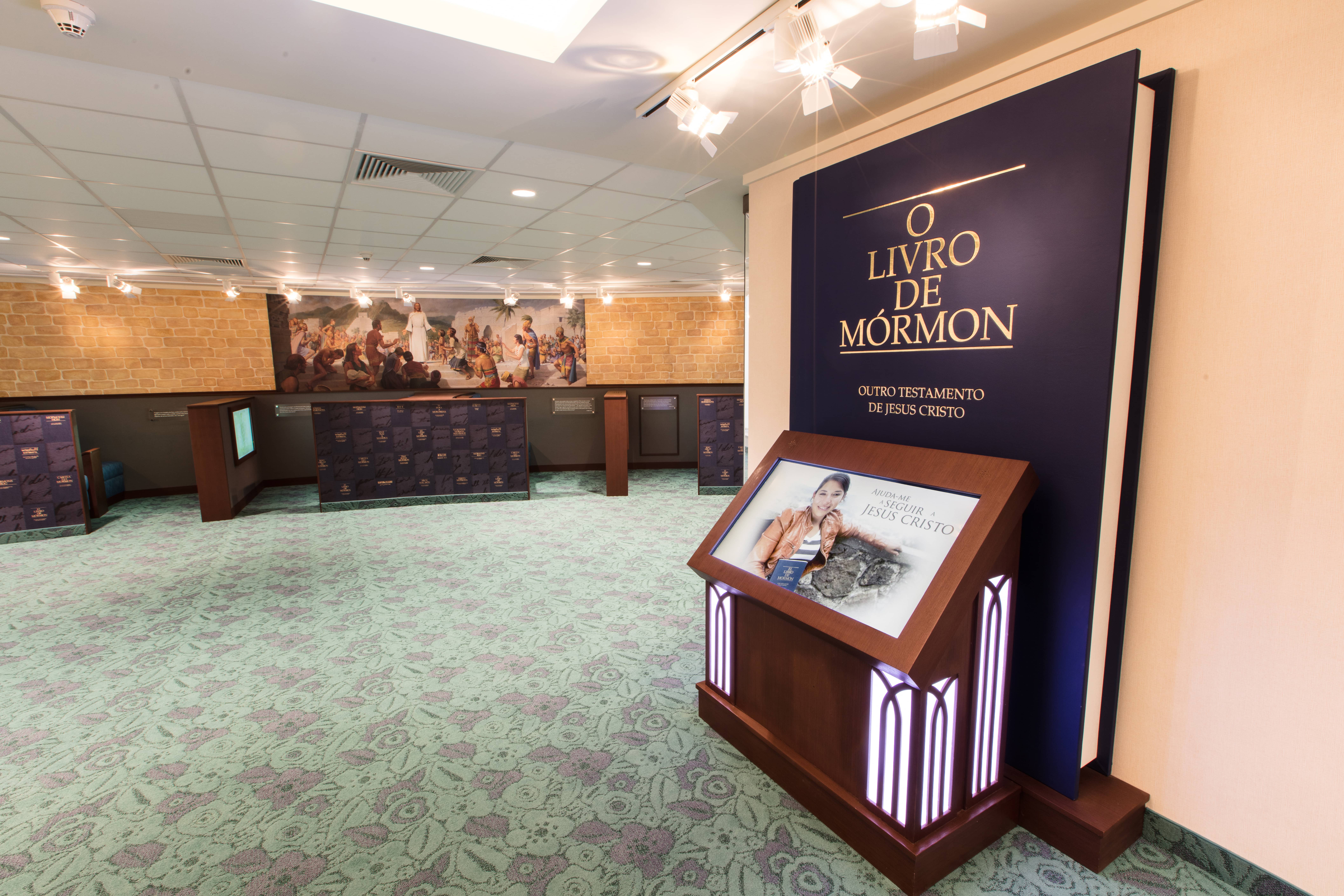 A giant replica of a copy of the Book of Mormon stands against the wall.