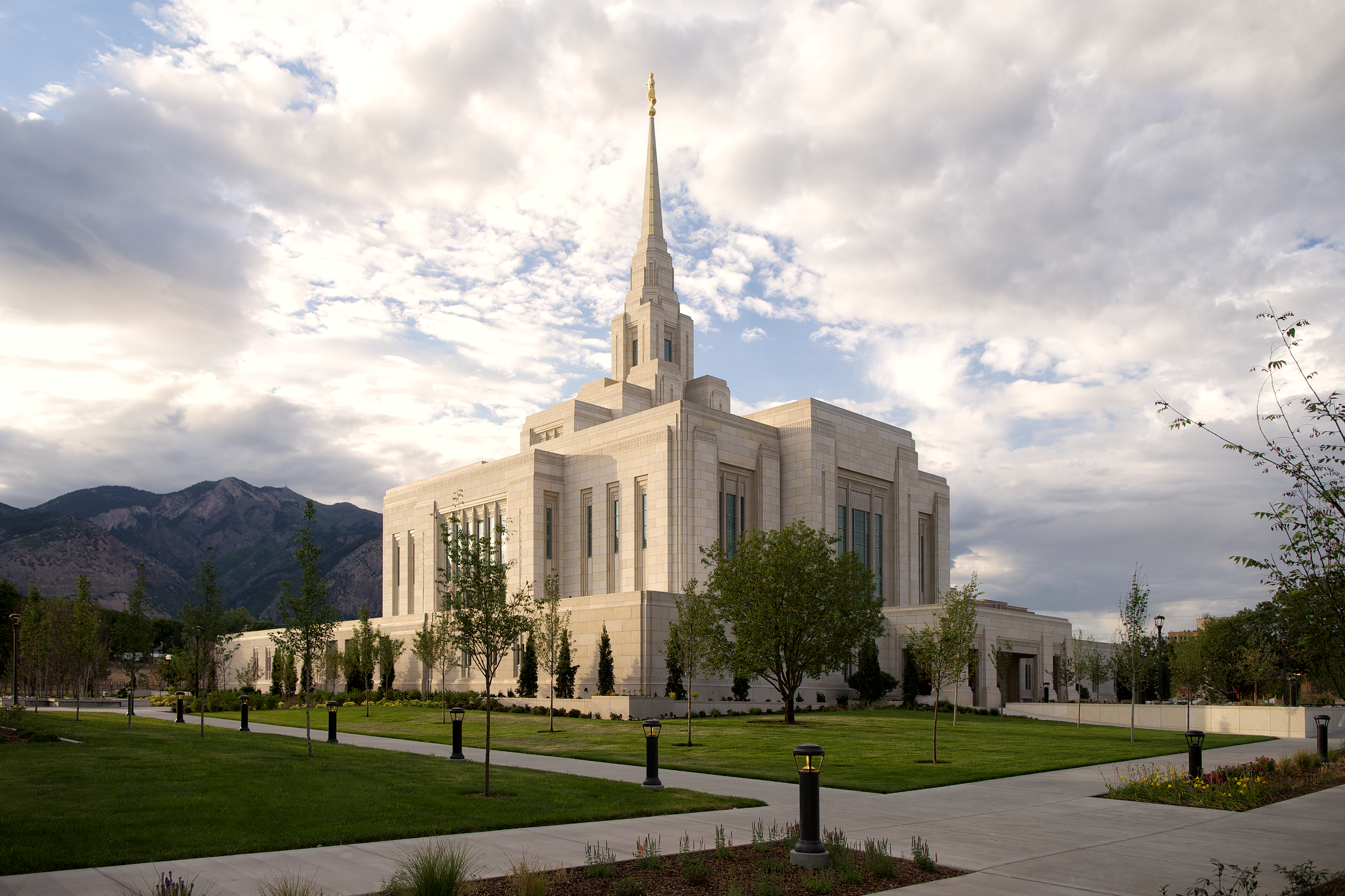The exterior of the Ogden temple, a white, multilevel, blocky building with a center spire.