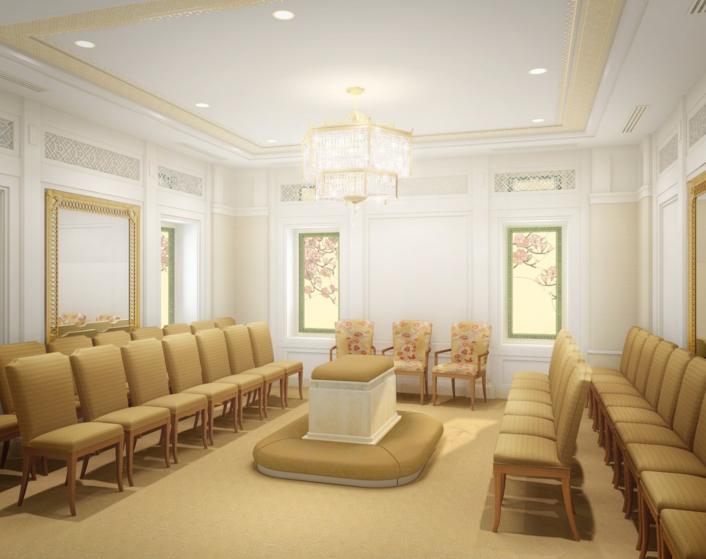 A white room with rows of chairs around an alter and a chandelier on the ceiling. 