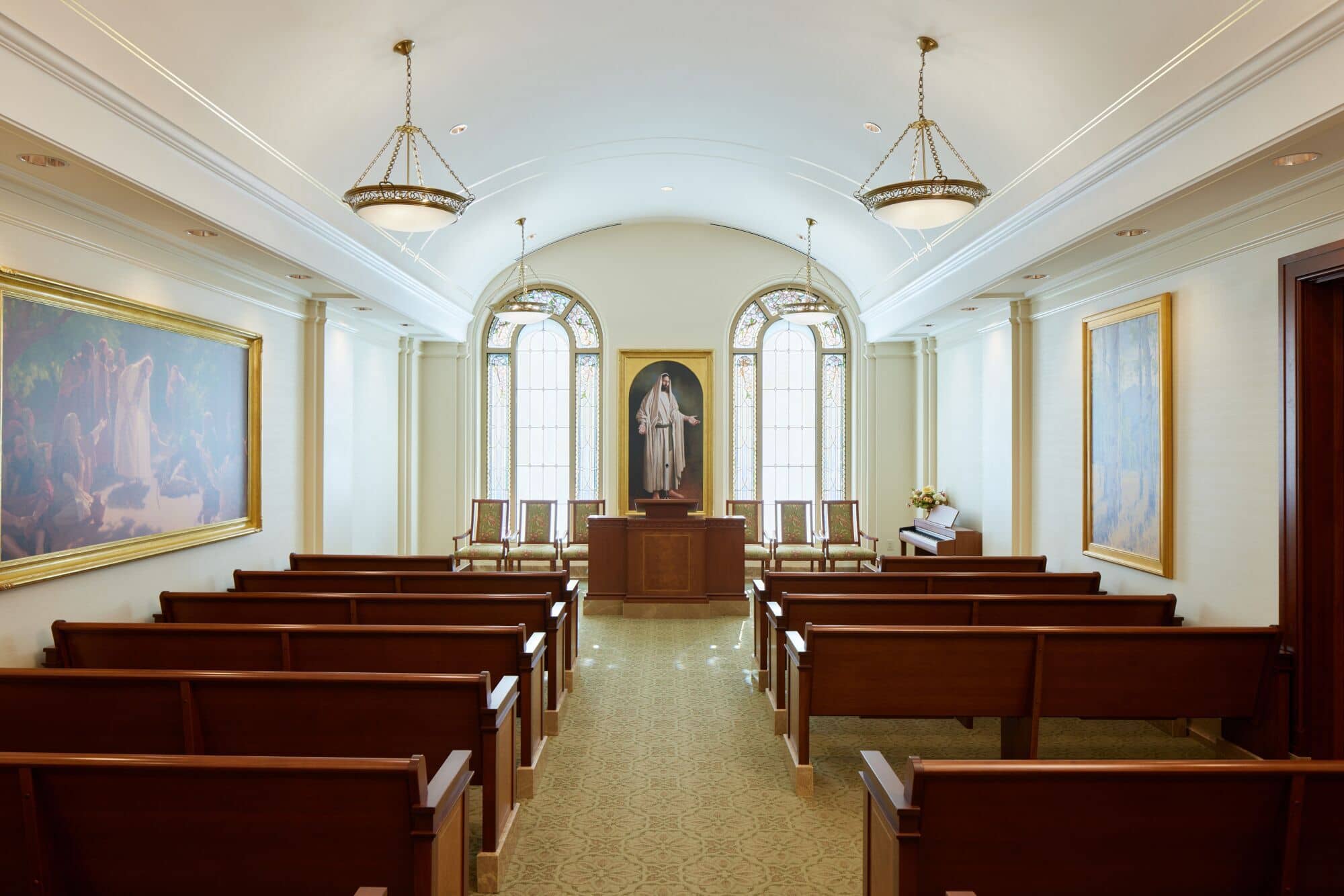 A white room with dark-wooden furniture in the Feather River temple.