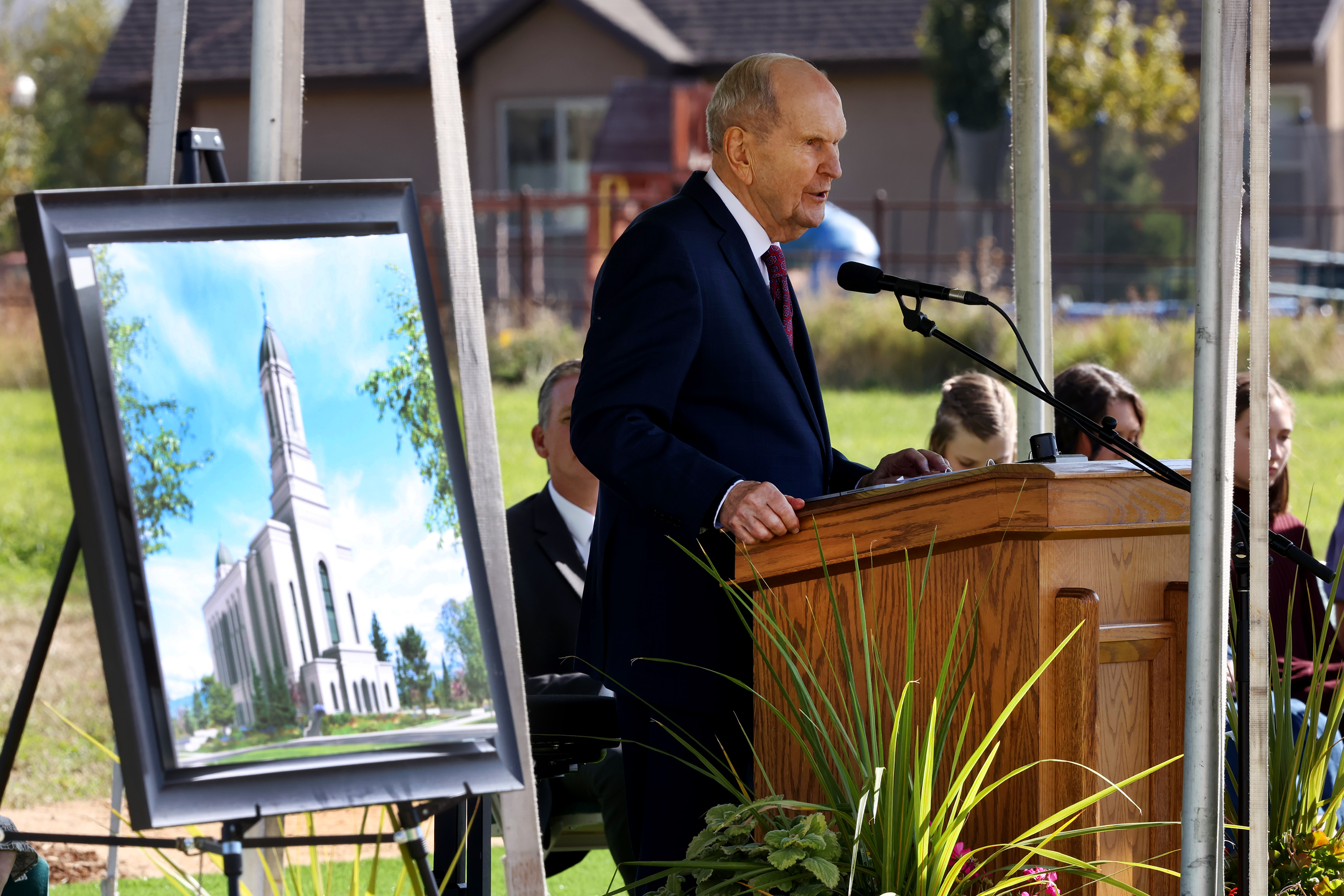 President Russell M. Nelson speaking at a pulpit outside.