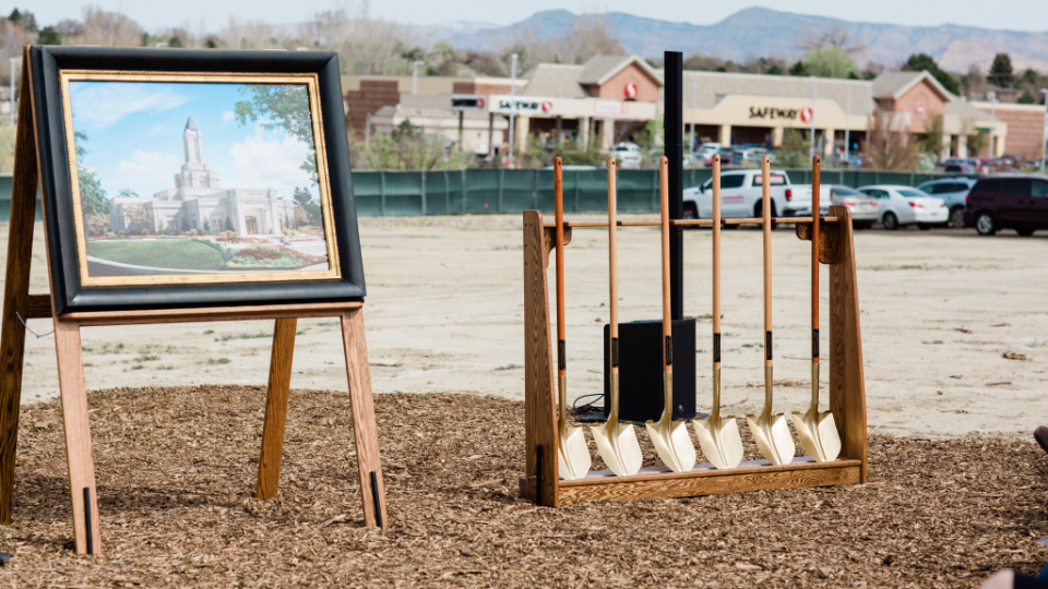 Ceremonial shovels lined up next to the temple rendering for the Grand Junction Colorado Temple groundbreaking.