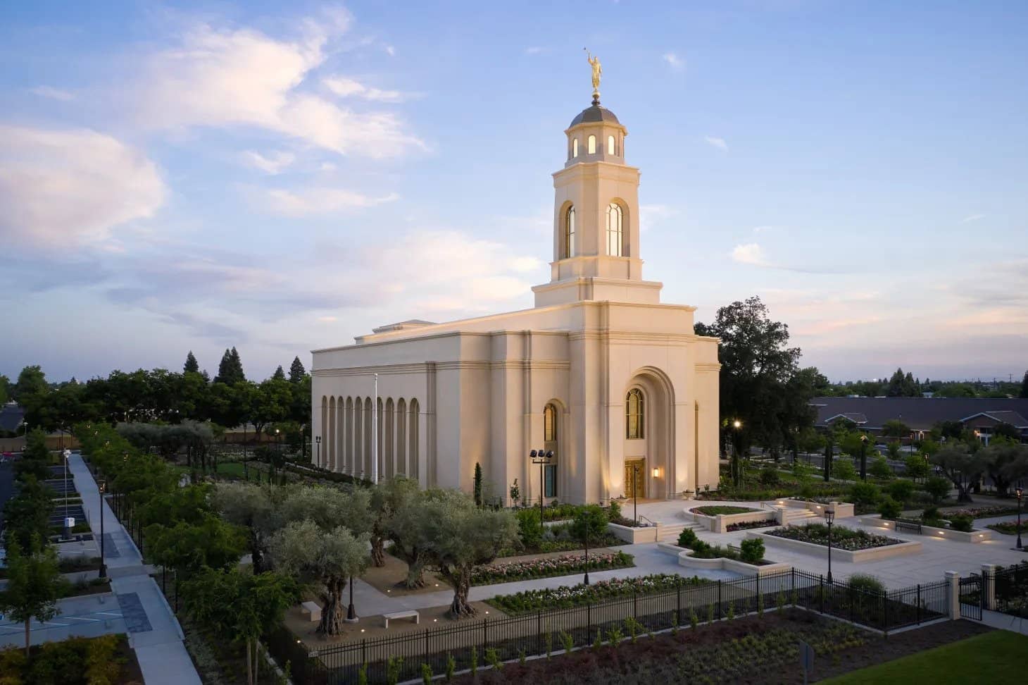 The exterior of the Feather River California Temple, a white building with a center spire near the front.
