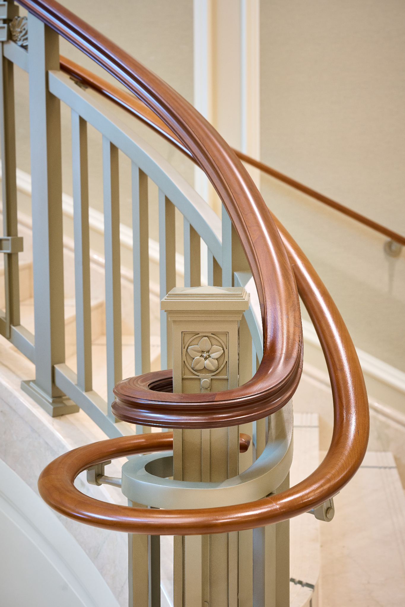 A close-up of light-wood railing next to a staircase.
