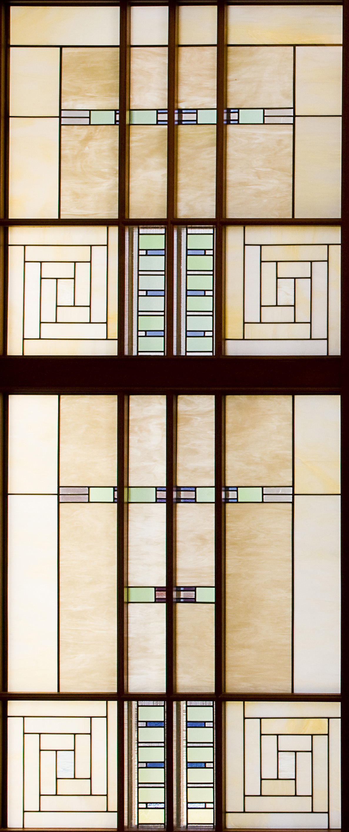 A close-up of an art-glass window with rectangle designs throughout.