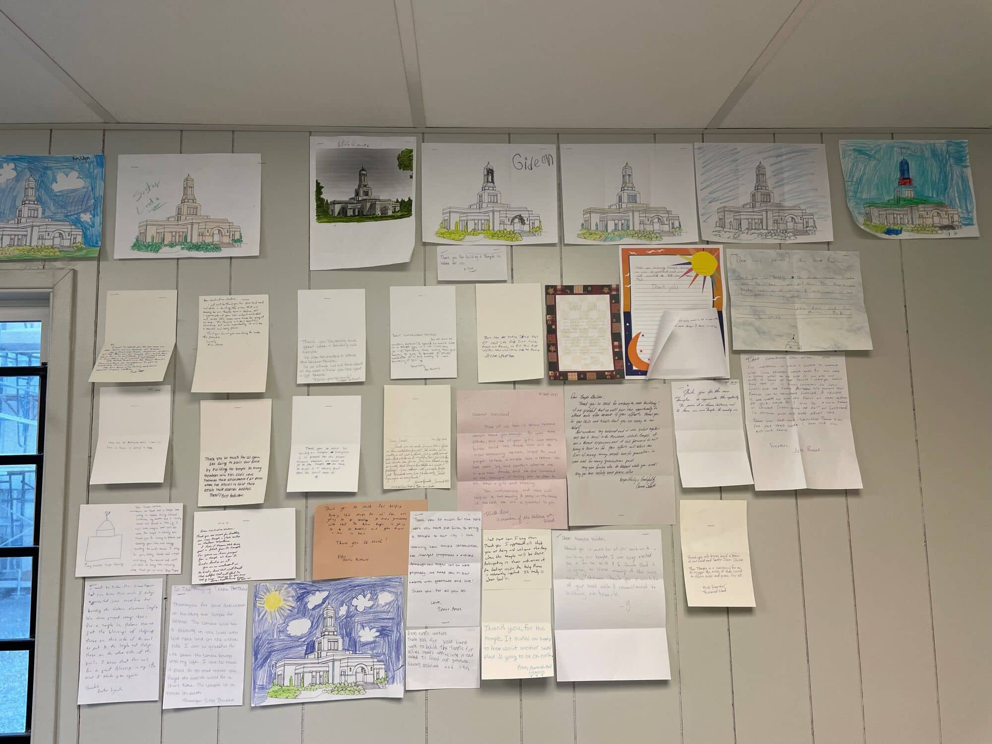 Many thank-you letters and colored pictures of the Helena Montana Temple hanging on walls.