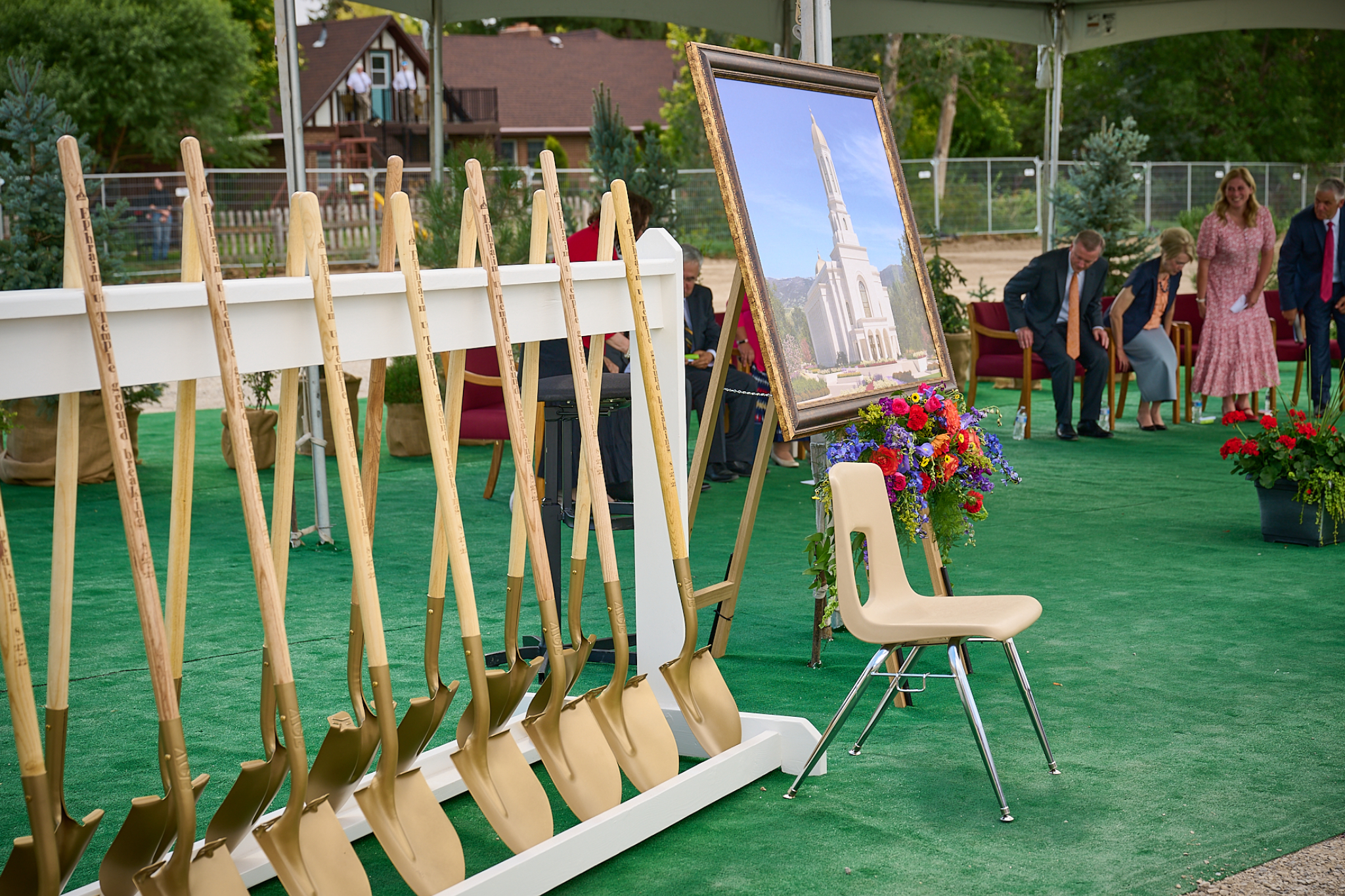 A row of ceremonial golden shovels standing up.