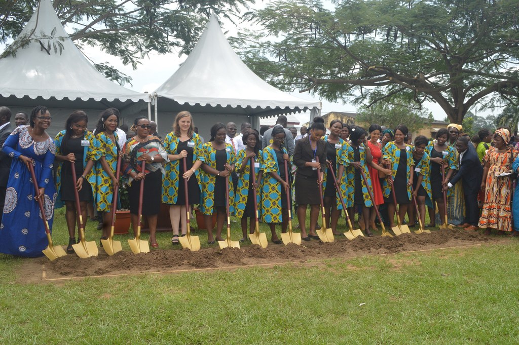 A row of Latter-day Saint sisters holding ceremonial golden shovels and breaking ground on the Abidjan temple site.